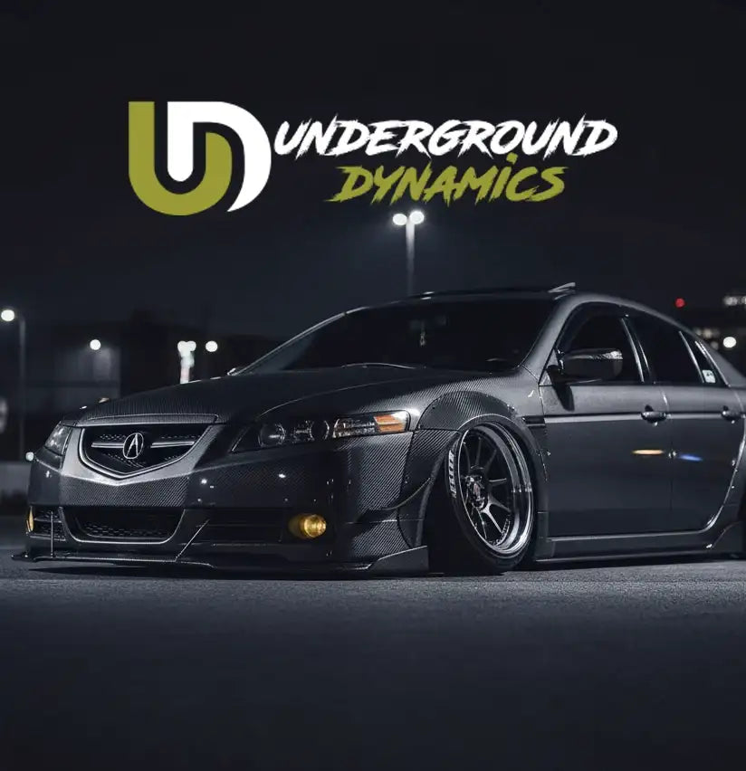 Black carbon fiber acura tsx with custom widebody kit and aftermarket wheels.